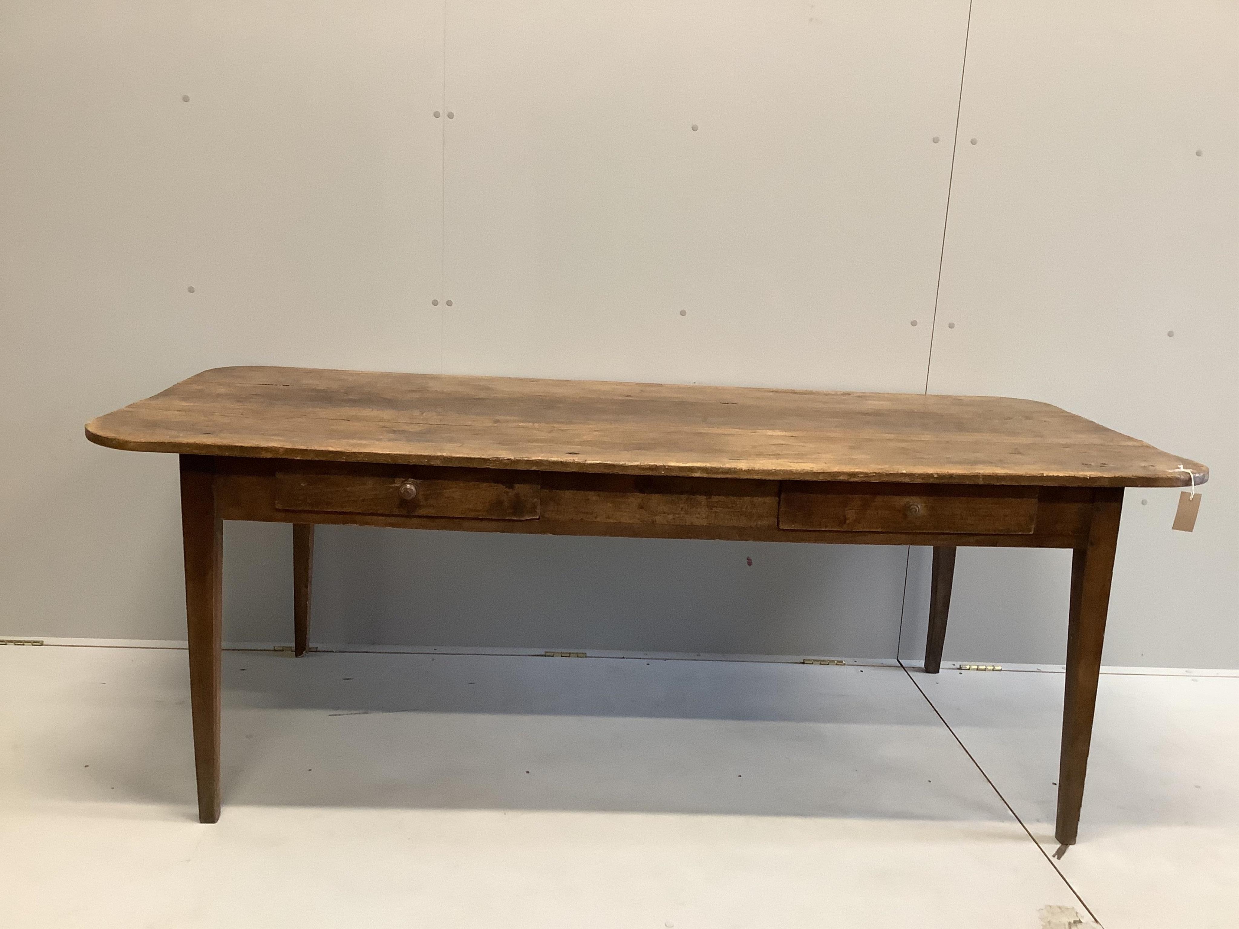 A 19th century French rectangular fruitwood kitchen table, width 200cm, depth 88cm, height 72cm. Condition - fair